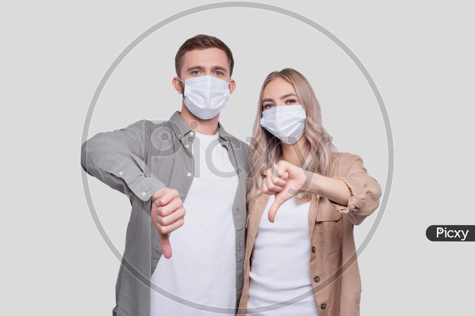 Couple Wearing Medical Mask Showing Thumb Down Isolated. Man And Woman Hugging, Lovers, Friends, Couple, Virus Concept