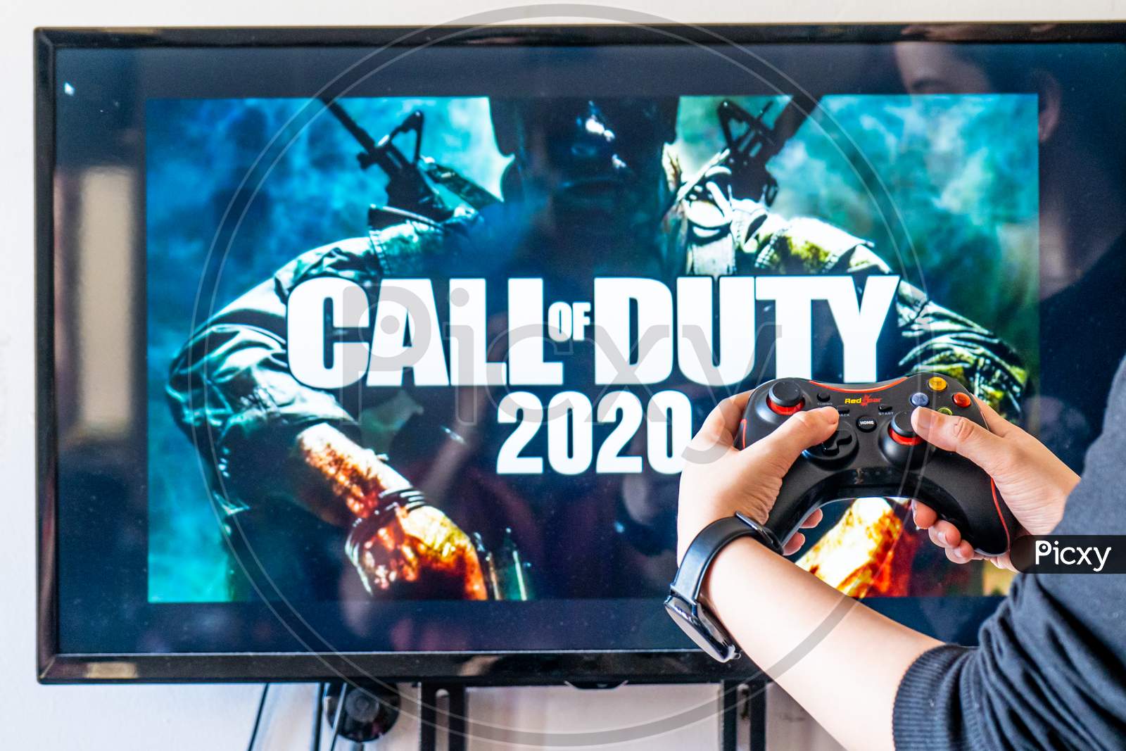 Woman Holding A Generic Controller And Playing Popular Video Game Call Of Duty On A Television And Pc