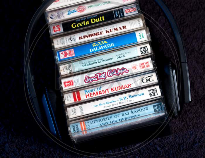 A lovely picture of Antique Music Audio tapes which were a rage in 1970-80s the world over with a Headphone against a dark background on Coffee table
