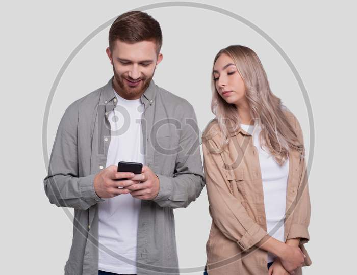 Manchatting On Phone. Couple Using Phones Standing Isolated. Couple Shopping Online. Girl Watching In Man Phone. Secret In Phone.