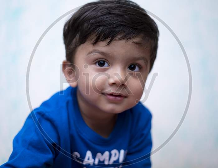 Portrait Of A Young Indian Infant Kid With Innocent Eyes.