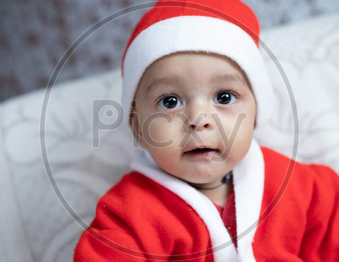 Portrait Of Baby In Santa Costume