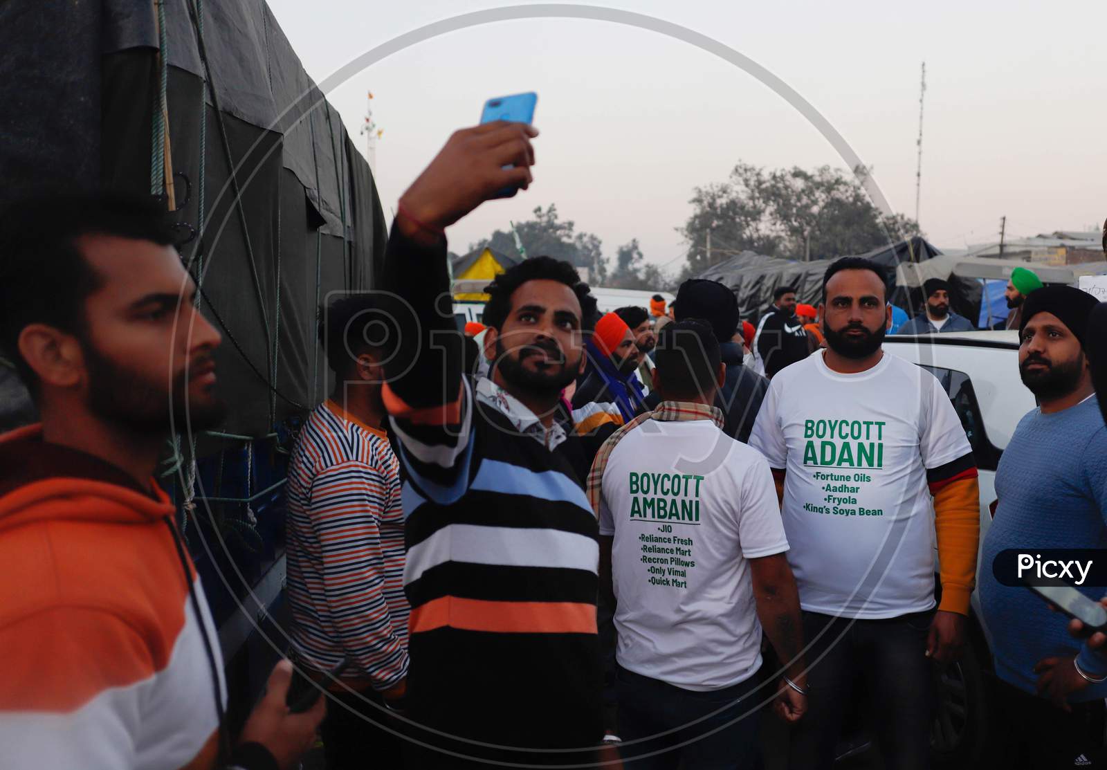 Farmers Wearing T-Shirts With A Slogans “Boycott Adani, Boycott Ambani’ To Protest Against Corporate Businesses Following The Recent Passing Of Agriculture Reform Laws, At Singh Border, On December 13, 2020 In New Delhi, India. Thousands Of Farmers Are Protesting On Various Borders Of The National C