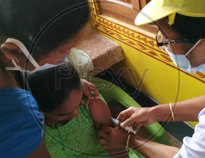 A healthcare provider injecting a vaccine