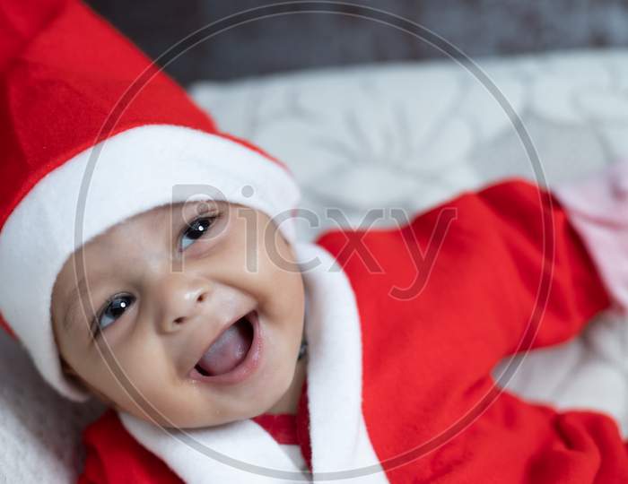 Portrait Of Baby Smiling In Santa Costume