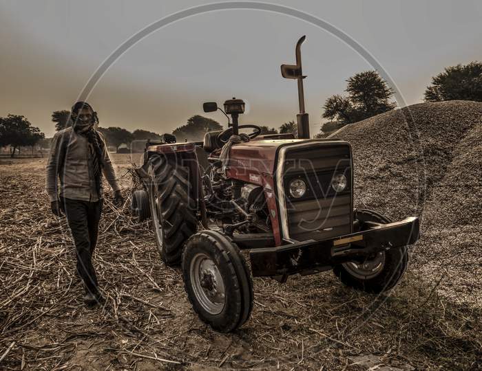Farmer With Tractor At Work