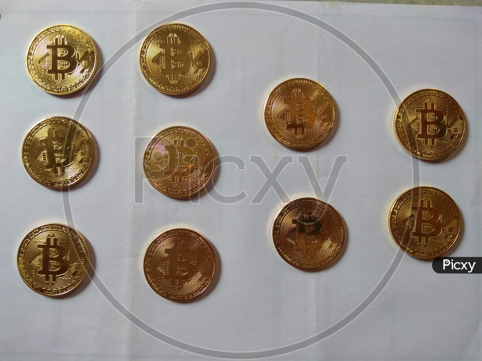 Multiple Physical Bitcoin Art Coins Front View Golden Coated Shining