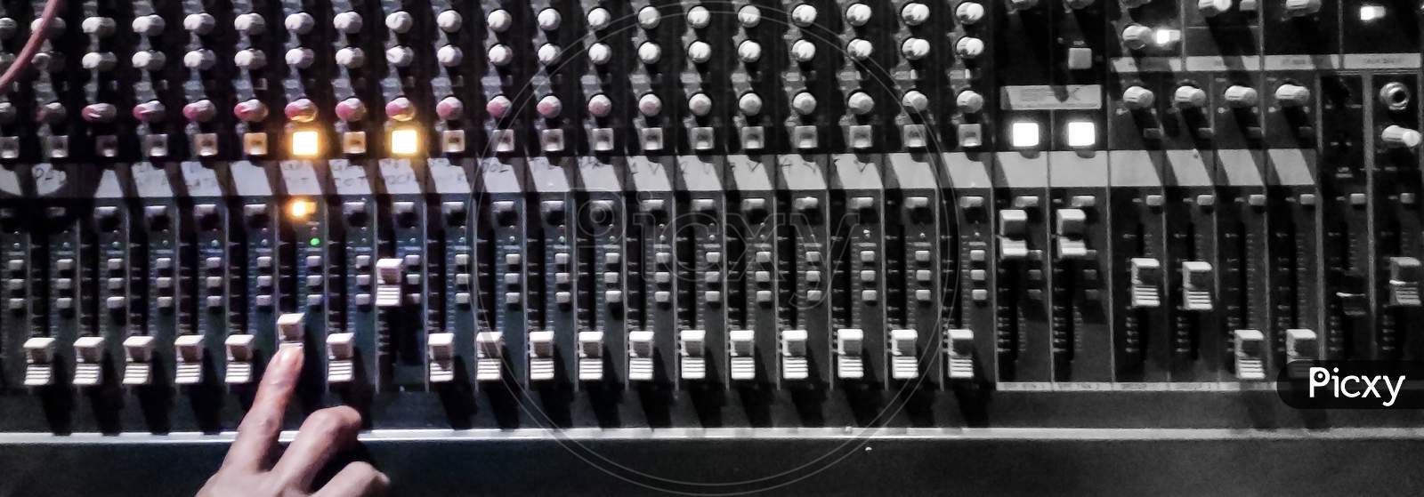 Audio Console.Amplifying Equipment That Adjusts Studio Audio Mixer Knobs And Faders. Workplace And Equipment Of The Sound Engineer. Acoustic Mixing Of Music, Selective Focus. Banner.
