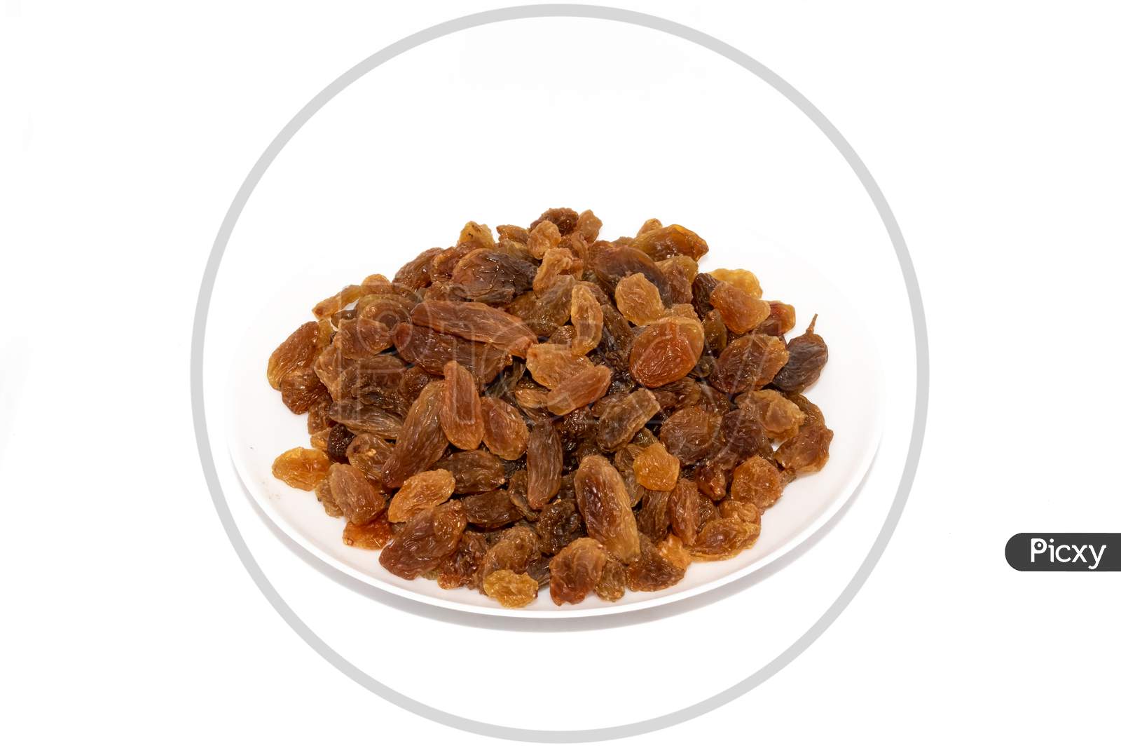 Golden raisins on plate on white background