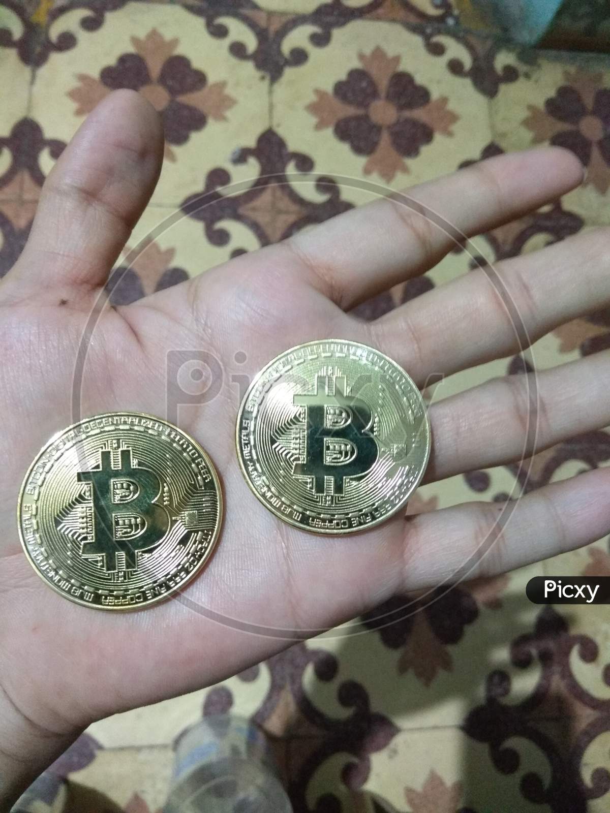 Two Physical Golden Bitcoins Coin Cryptocurrency in Hand