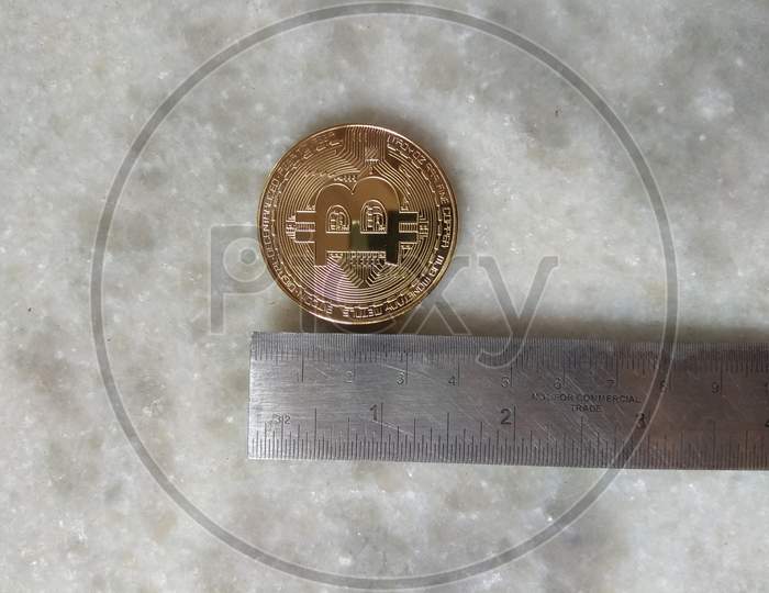 Physical Gold Coated Bitcoins Coin Cryptocurrency Measurement With Foot Scale