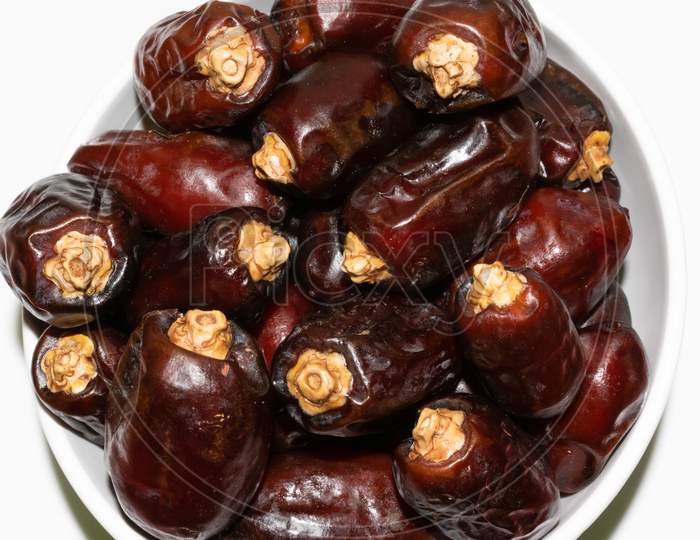 Brown color Arabian dates top view isolated on white background
