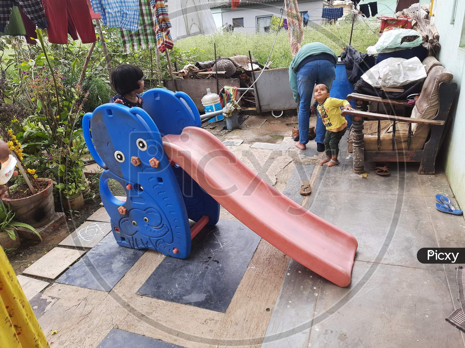 Group of Indian Kids Playing in a Mobile Plastic slides, climbers in front of the house