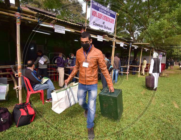 Polling officers carry election materials as they leave from a distribution centre for Tiwa Autonomous Council election 2020, in Nagaon District of Assam , Wednesday, Dec. 16, 2020.