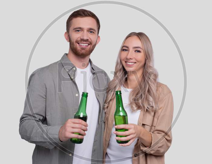 Couple Holding Beer Bottle Isolated. Couple Standing And Holding Beer Bottles. Man And Woman Hugging, Lovers, Friends, Couple Concept.
