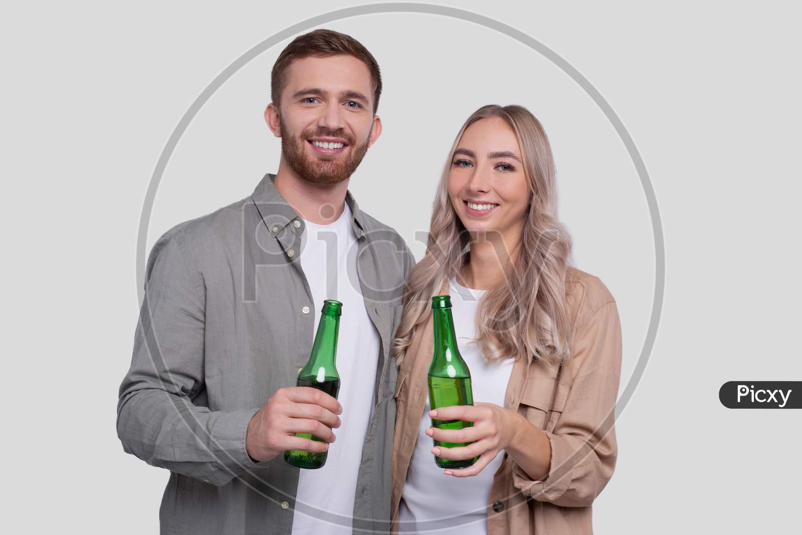 Couple Holding Beer Bottle Isolated. Couple Standing And Holding Beer Bottles. Man And Woman Hugging, Lovers, Friends, Couple Concept.