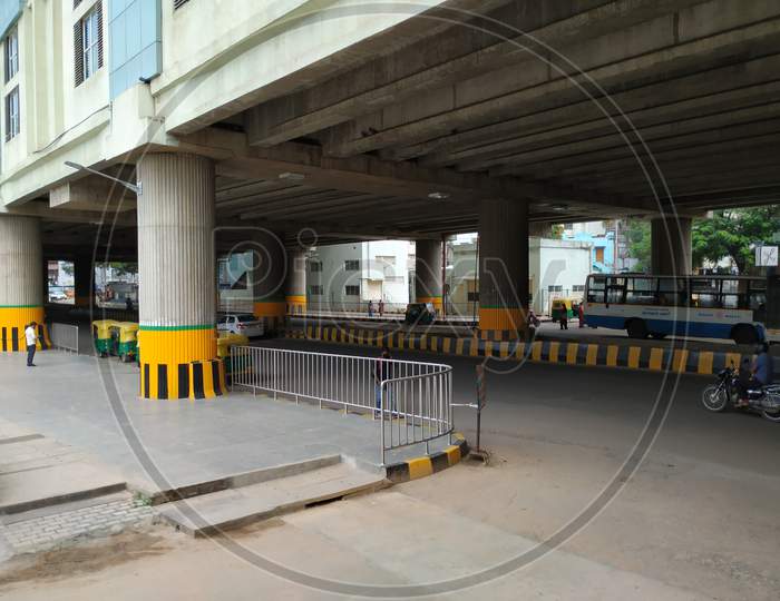 Closeup Of Vehicles Moving Under The Flyover Or Building Of The Yelachenahalli Metro Station Green Line.