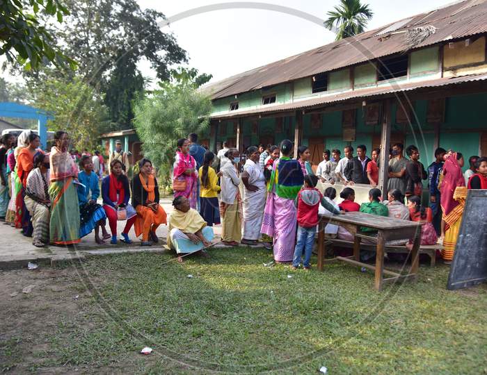 Voters wait in a queue to cast their votes for elections 2020, at a polling station  during  Tiwa Autonomous Council election 2020  in Morigaon  district, in the northeastern state of Assam on Dec 17,2020.