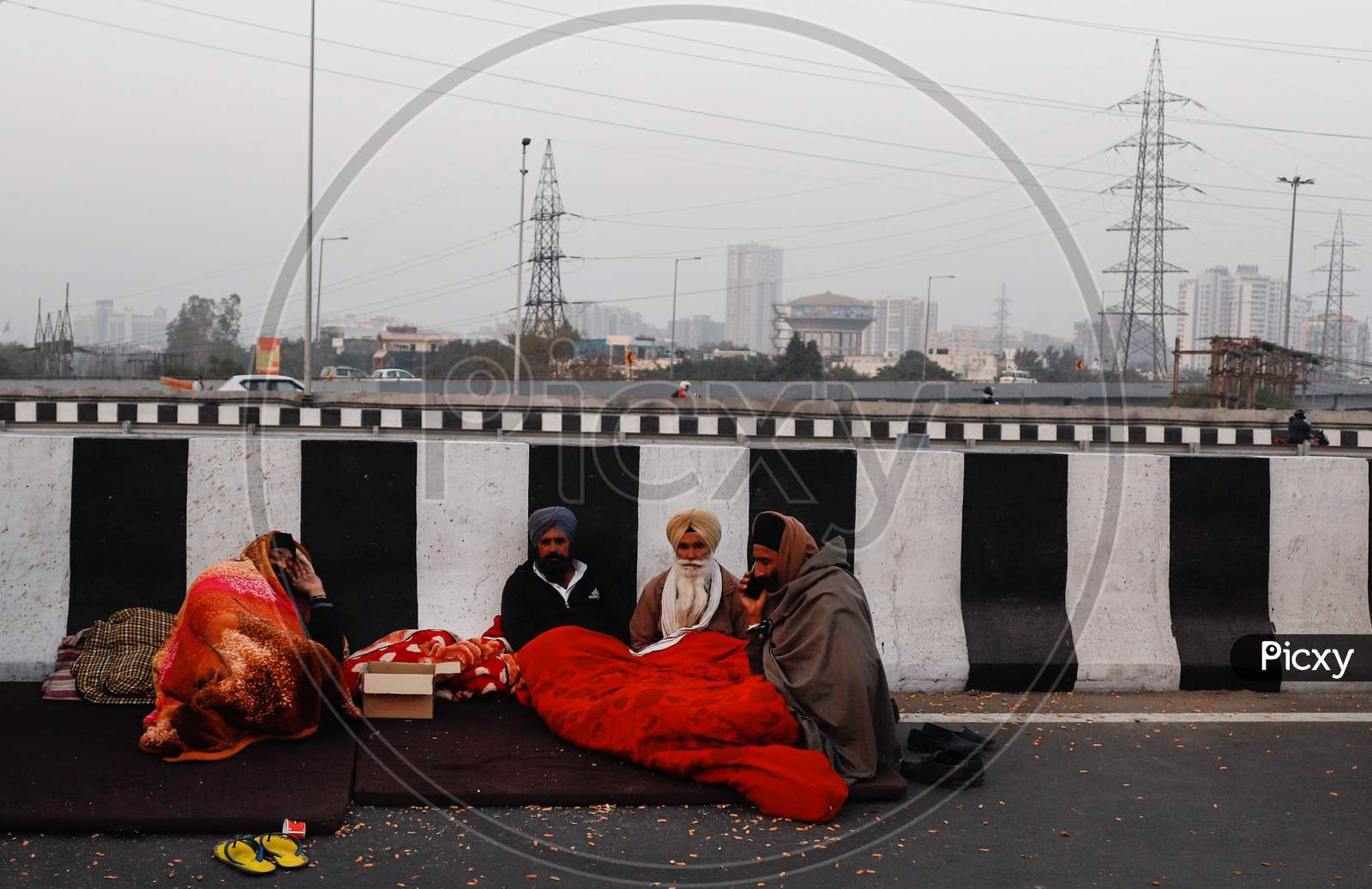 Farmers Sits On A Blocked National Highway At Gazipur Border Near New Delhi, On December 17, 2020, During An Ongoing Sit-In Protest Demanding The Rollback Of 3 Government Agricultural Reforms Bill. More Than 20 Protesters Have Died Since The Agitation Began In November-End, Farmer Groups Claim.