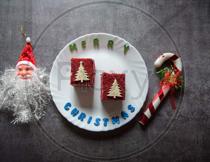 Red velvet cake on a plate along with christmas decoration