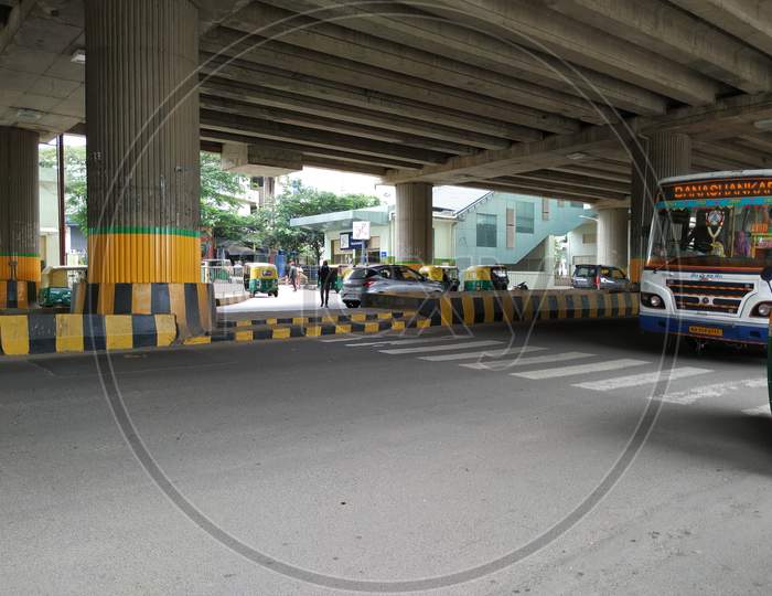 Closeup Of Vehicles Moving Under The Flyover Or Building Of The Yelachenahalli Metro Station Green Line.