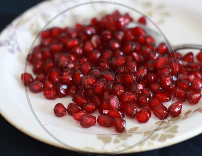 The pomegranate seeds on a plate.