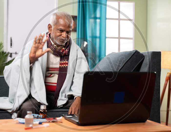 Sick Old Man On Video With To Doctor On Laptop At Home - Concept Of Online Chat, Telehealth, Or Tele Counseling With Nurse Or Doctor During Coronavirus Or Covid-19 Pandemic.