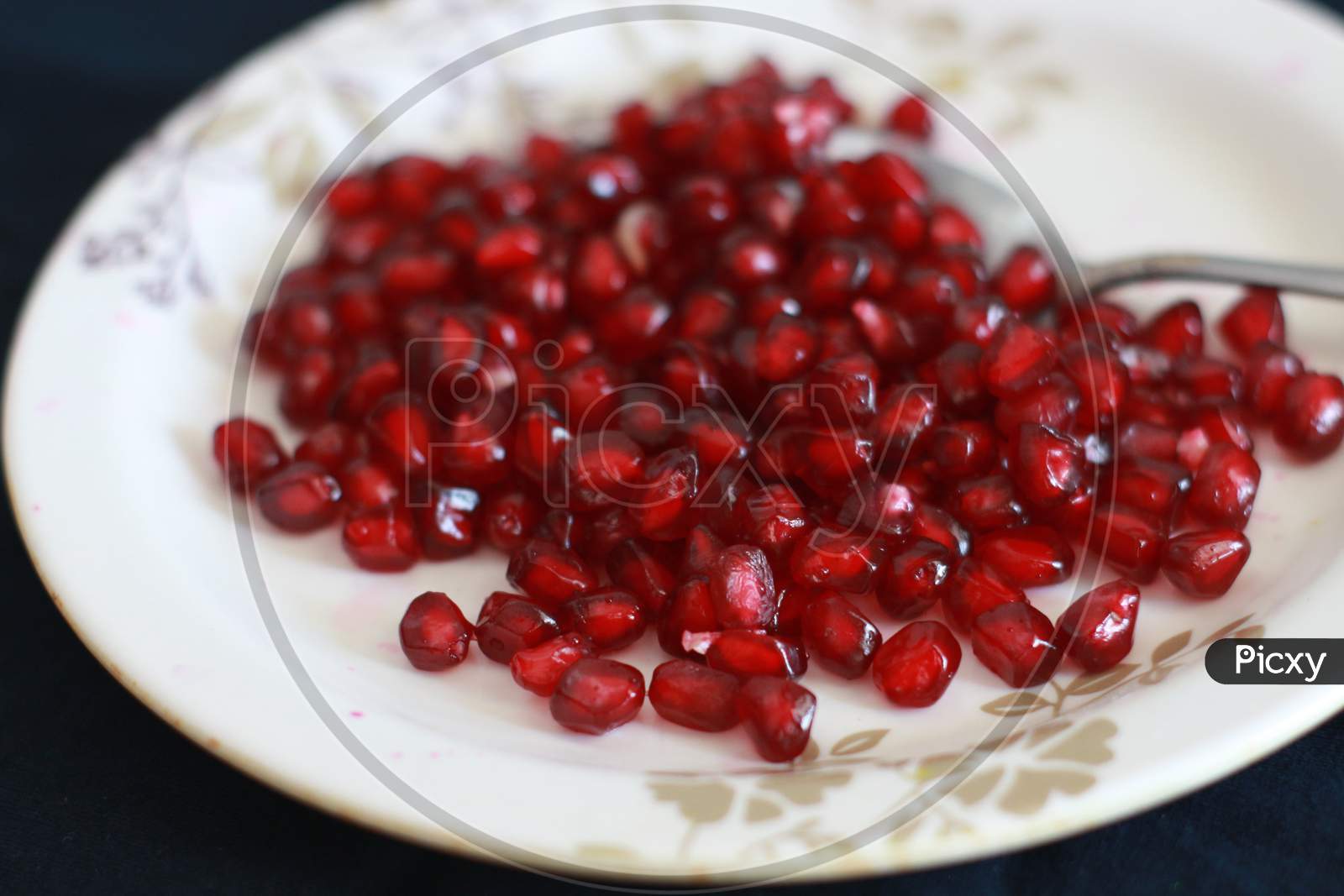 The pomegranate seeds on a plate.