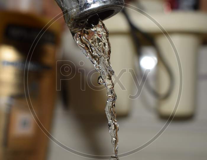 water dripping out of tap running down and captured with camera