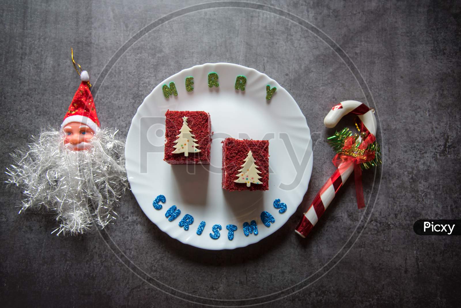 Red velvet cake on a plate along with christmas decoration