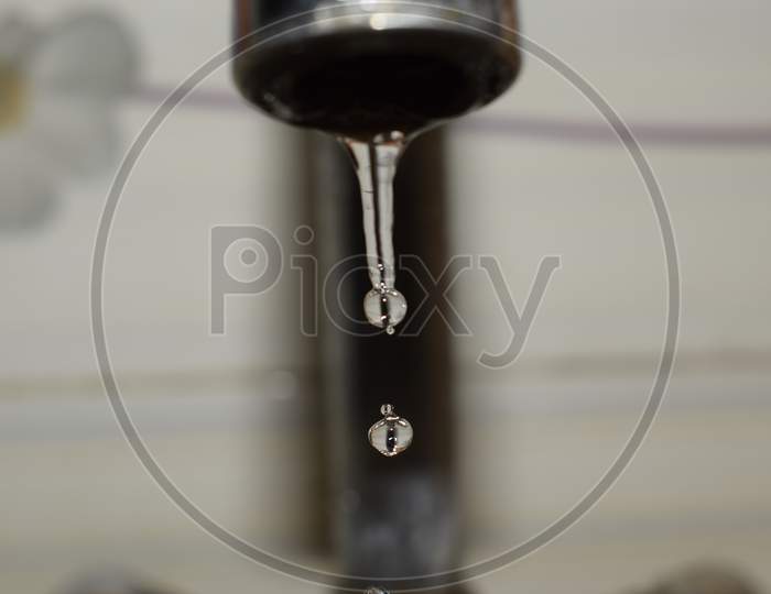 water dripping out of tap running down and captured with camera
