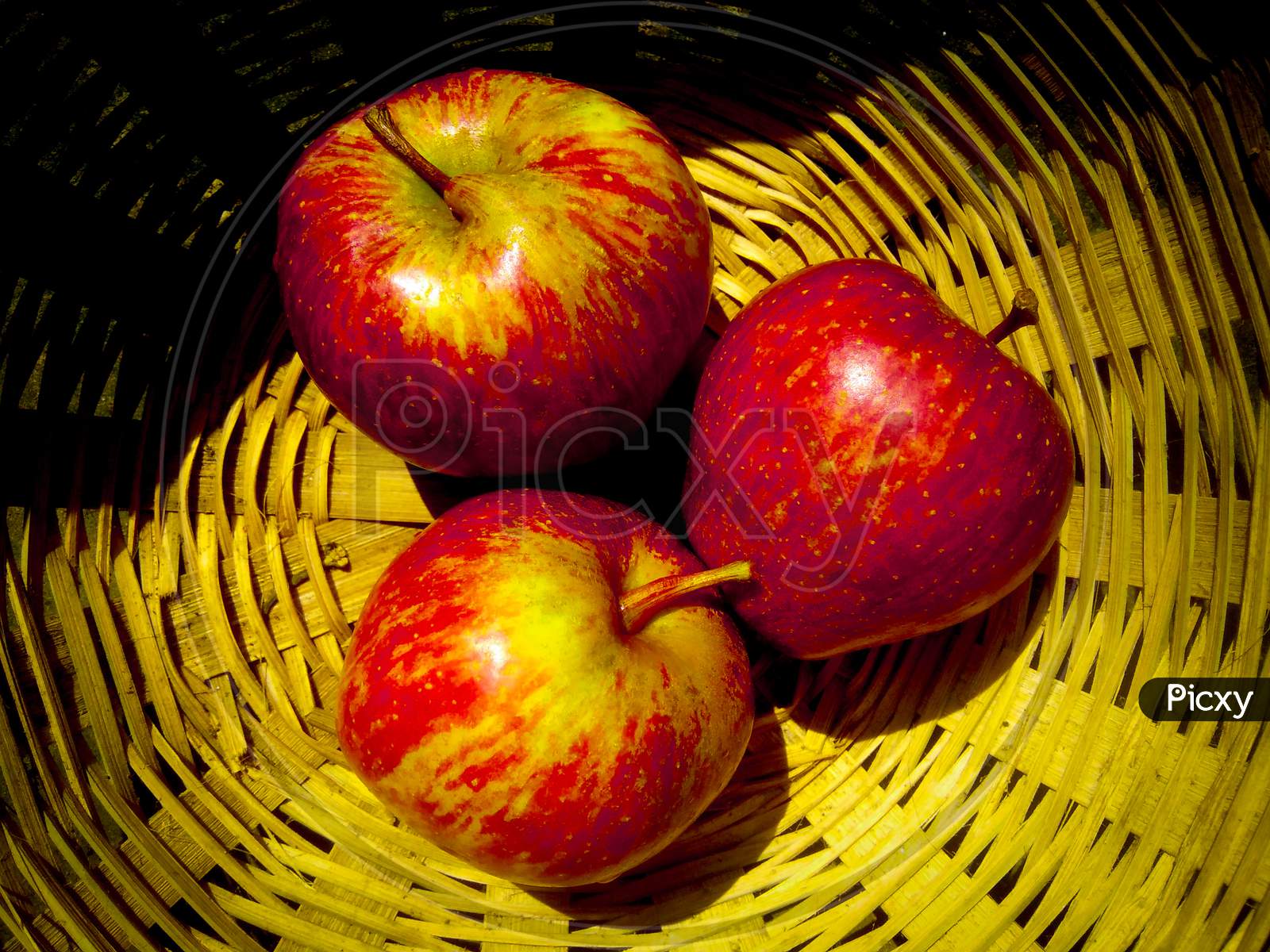 Apples in the basket. Three apples are in the basket.