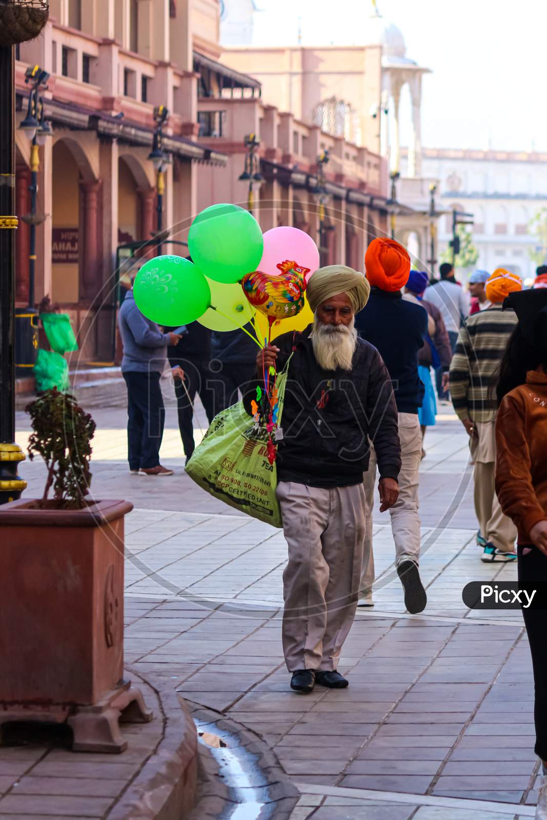 An old man vendor selling balloons on the street