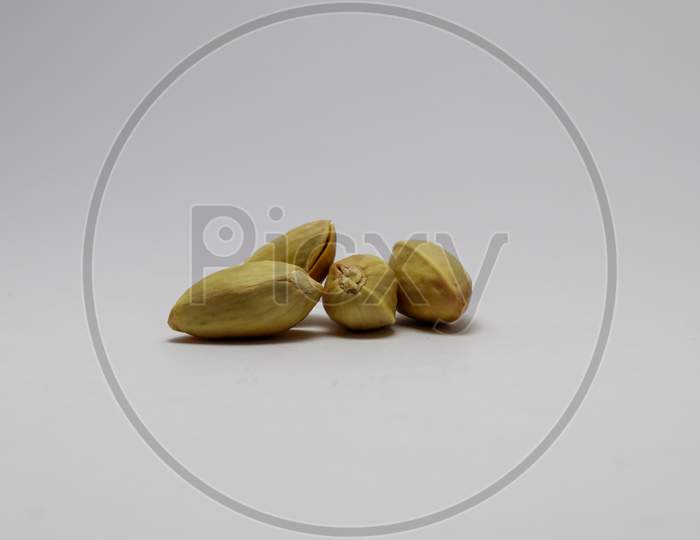 Bunch of Pistachio in the glass bowl and with white background and perfect lighting condition