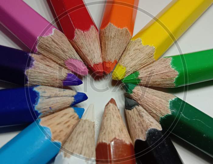 Multicolored pencils in white background