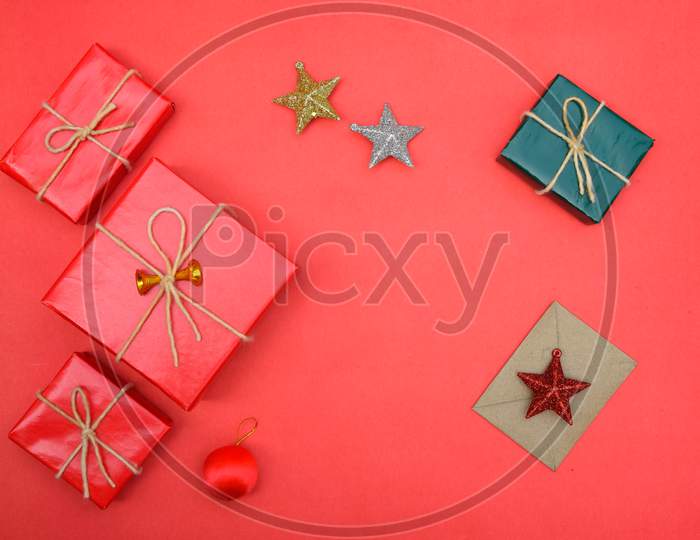 Christmas Background With Gift Boxes, Clews Of Rope, Paper'S Rools And Decorations On Red. Preparation For Holidays. Top View With Copy Space.