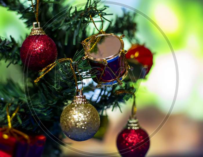 Close Up Of Balls On Christmas Tree. Bokeh Garlands In The Background. New Year Concept.