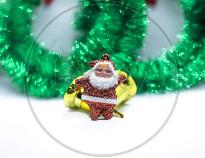 Christmas Garland Decorated With Ornaments, Gold Bell And Santa Claus Isolated On A White Background
