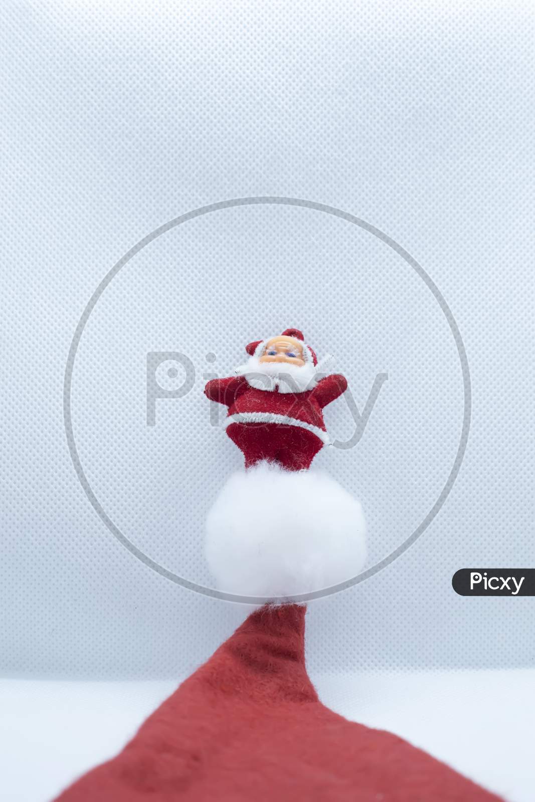 Santa Claus Stands Above The Hat On A White Background