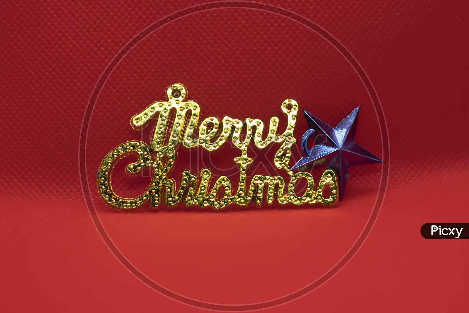 Merry Christmas Text With Star On Red Background. Holiday Festive Celebration Greeting Card With Copy Space