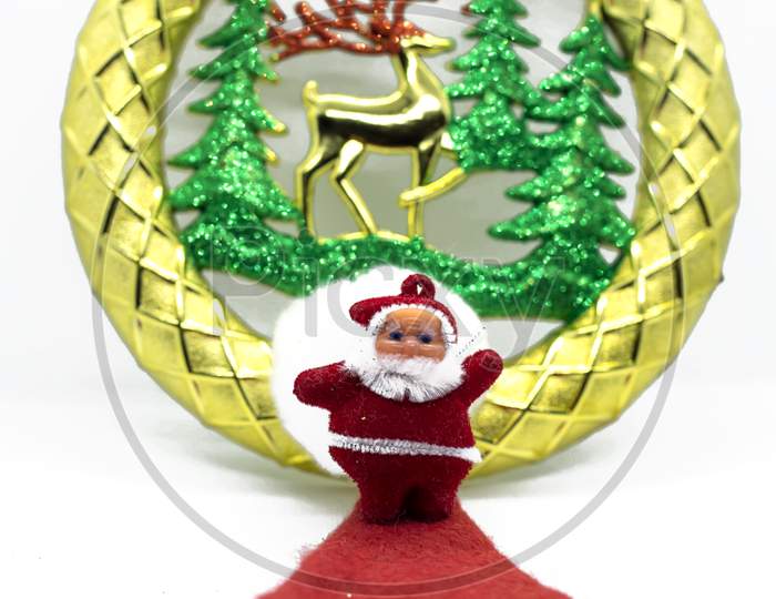 Santa Claus Stands On A Red Carpet With Gold Christmas Ornaments On A White Background