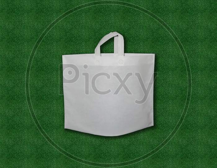 White Bag Isolated on green grass background.