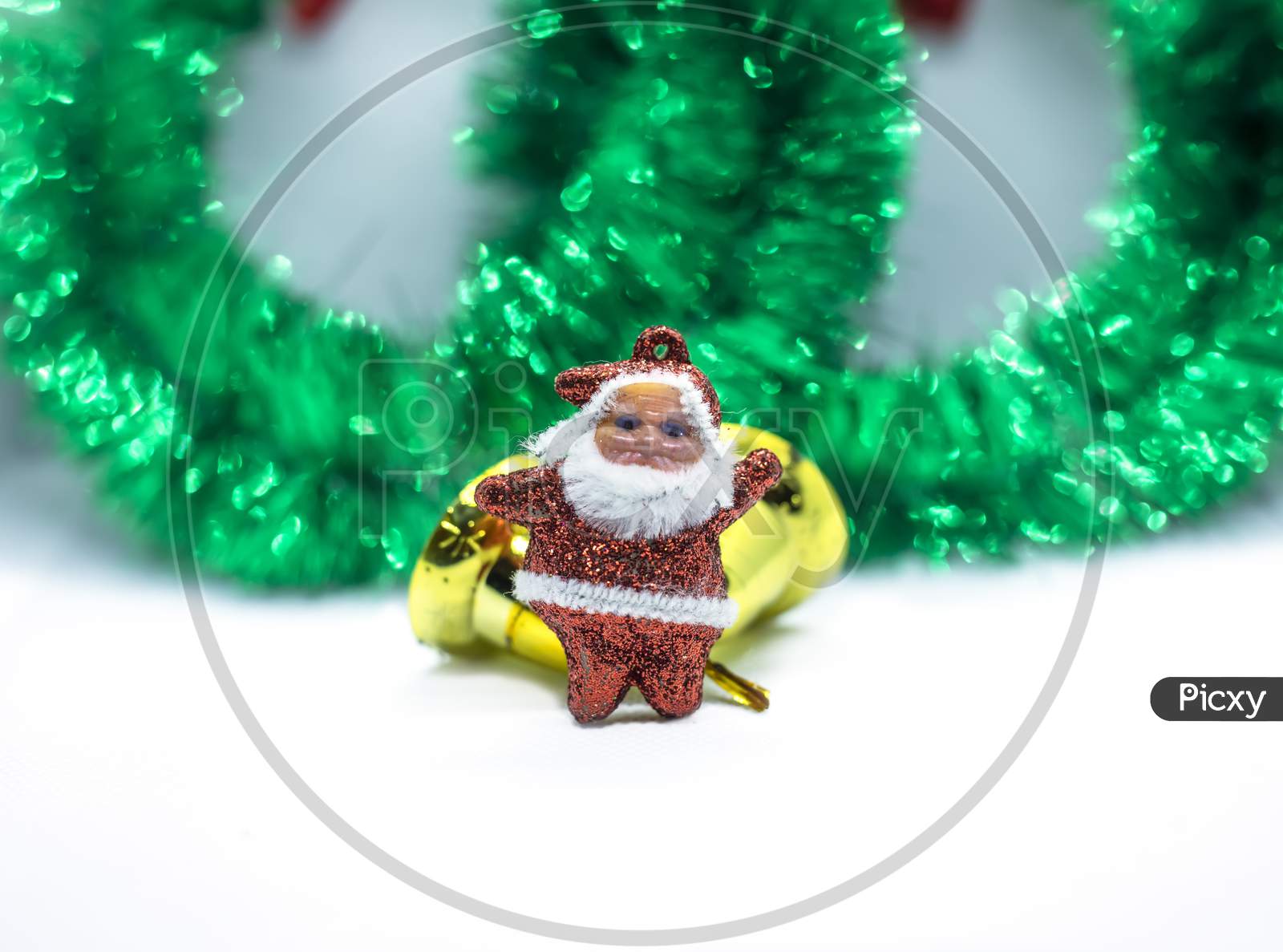Christmas Garland Decorated With Ornaments, Gold Bell And Santa Claus Isolated On A White Background