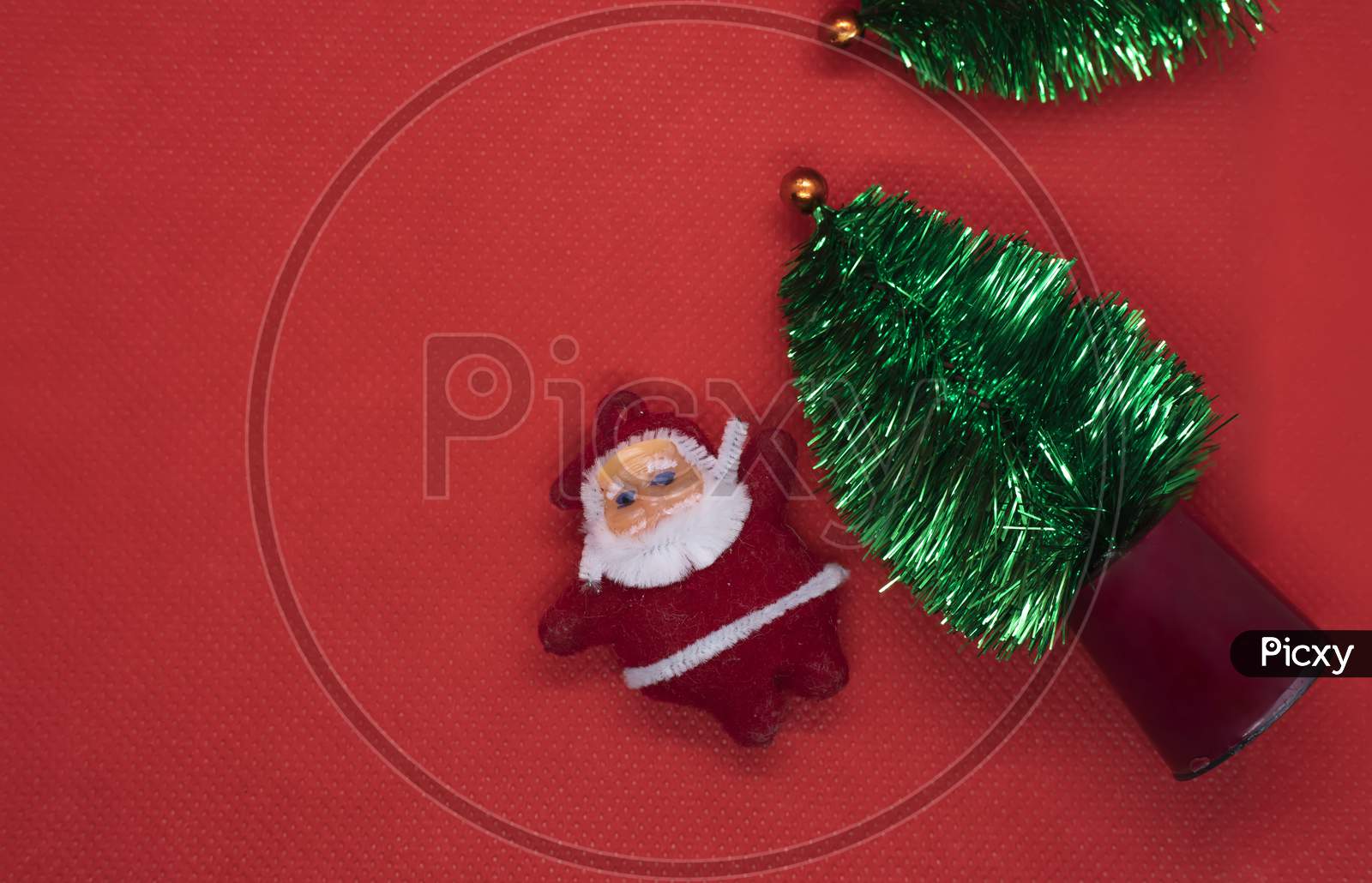 Top View Christmas Tree With Santa Claus On Red Studio Background. Copy Space