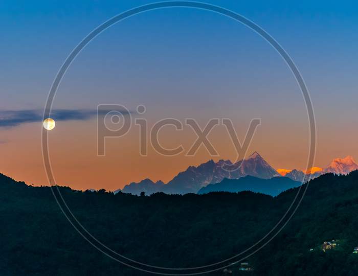 Full moon and golden top of Mt. Kanchenjunga