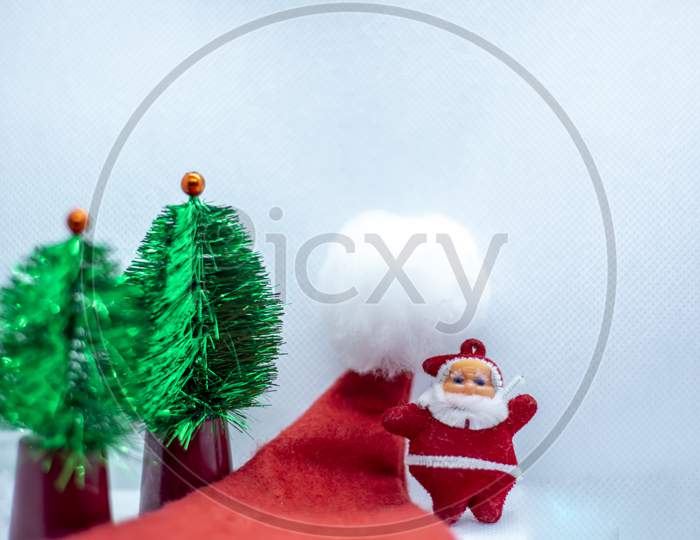 Santa Claus With A Hat Near A Tree On A White Background