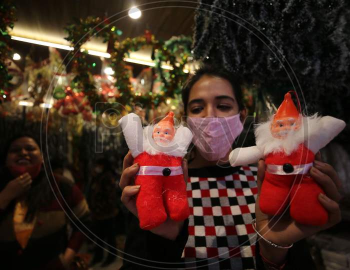 Girl buy decorative items from a shop ahead of Christmas in Jammu ,19 Dec.2020.