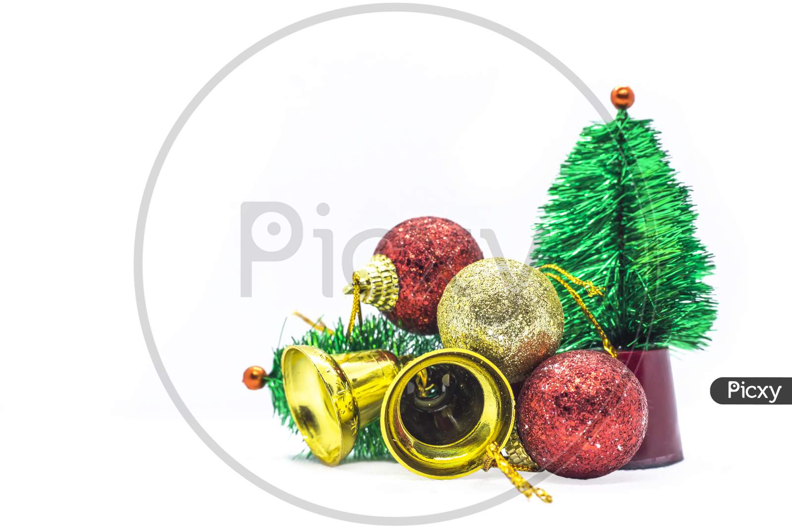 Miniatures: Small Christmas Tree, Golden Bells And Balls On White Background.