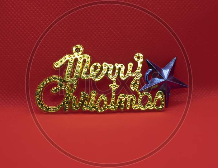 Merry Christmas Text With Star On Red Background. Holiday Festive Celebration Greeting Card With Copy Space