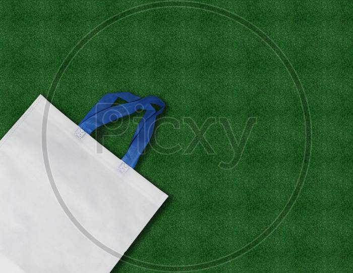 White Bag Isolated on green grass background.